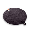 Baabuk dark grey round felted wool trivet hot plate with a leather hanging strap and brand tag
