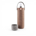 Baabuk moka wool wine cooler with leather strap and matching felt cup, designed for eco-friendly bottle insulation.