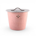 Baabuk small pink felted wool basket with a grey lid, leather handle, and Swiss cross cutout detail.