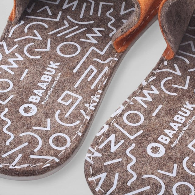 Baabuk Baabulette terracotta wool sandals with white geometric pattern on the footbed and natural rubber sole.