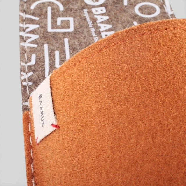 Baabuk Baabulette wool sandals in terracotta with a branded label and textured New Zealand wool upper.