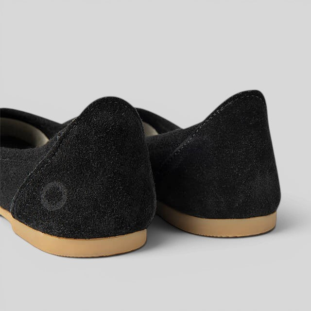 Baabuk black wool ballerina flats featuring a durable rubber sole and genuine nubuck heel detail.