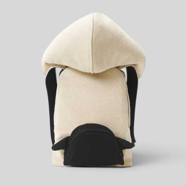 Baabuk Blacknose hooded backpack made from cream Swiss wool with black accents and adjustable shoulder straps.