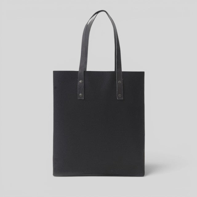 Baabuk Blacknose reversible tote bag in black wool with leather handles, handcrafted in Portugal.