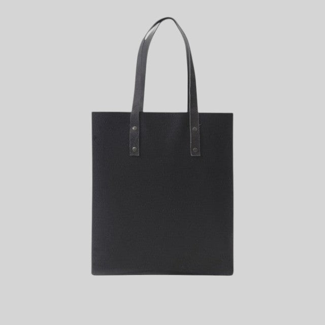 Baabuk Blacknose tote bag in black wool with leather handles, featuring a minimalist design and reversible interior.