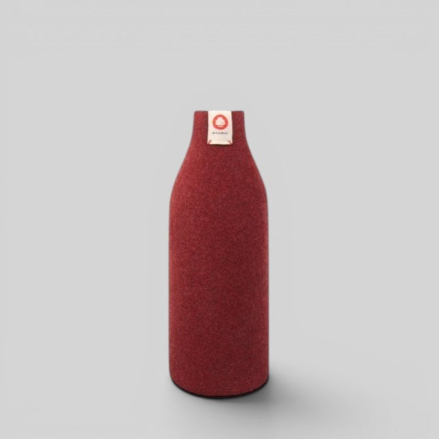 Baabuk bordeaux wool bottle cover with natural insulation and a small branded tag on a light grey background.