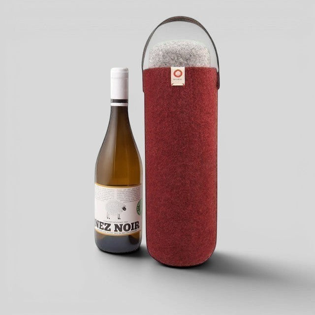 Baabuk Bordeaux wool wine cooler with a leather strap, keeping a wine bottle chilled for outdoor use.
