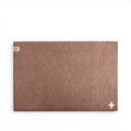 Baabuk brown felted wool table mat with Swiss cross detail, handmade from natural New Zealand sheep wool.