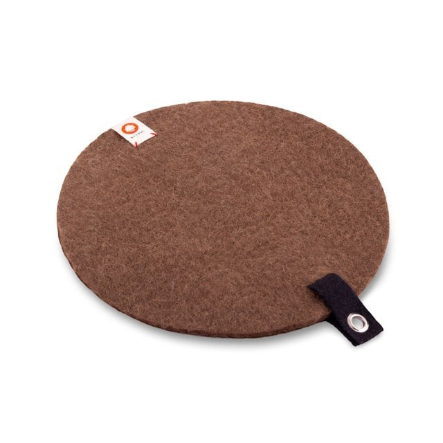 Baabuk brown round felted wool trivet hot plate with a small leather hanging strap for kitchen surface protection.