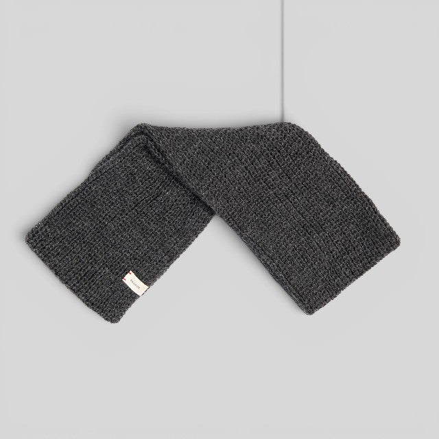 Baabuk dark grey infinity scarf made from soft baby alpaca wool with a ribbed knit texture and branded label.