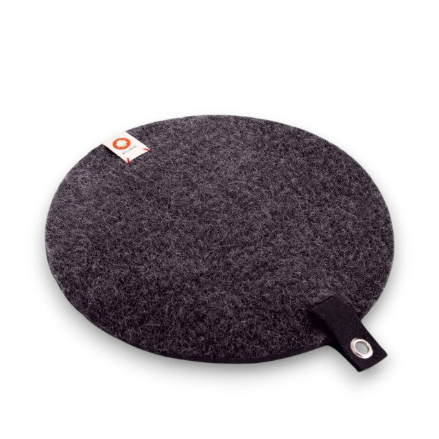 Baabuk dark grey round felted wool trivet hot plate with a leather hanging strap and brand tag