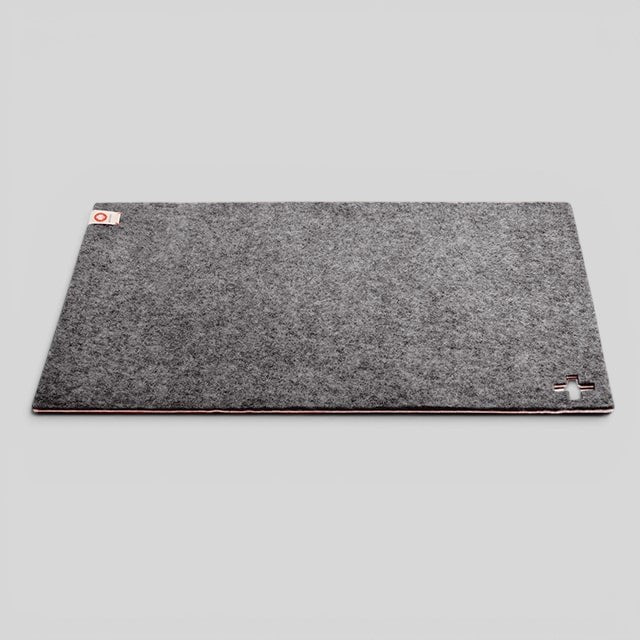 Baabuk dark grey felted wool table mat with Swiss cross detail, handmade from natural New Zealand wool.