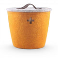 Baabuk large honey yellow felted wool basket with a grey lid, leather handle, and Swiss cross cutout detail.