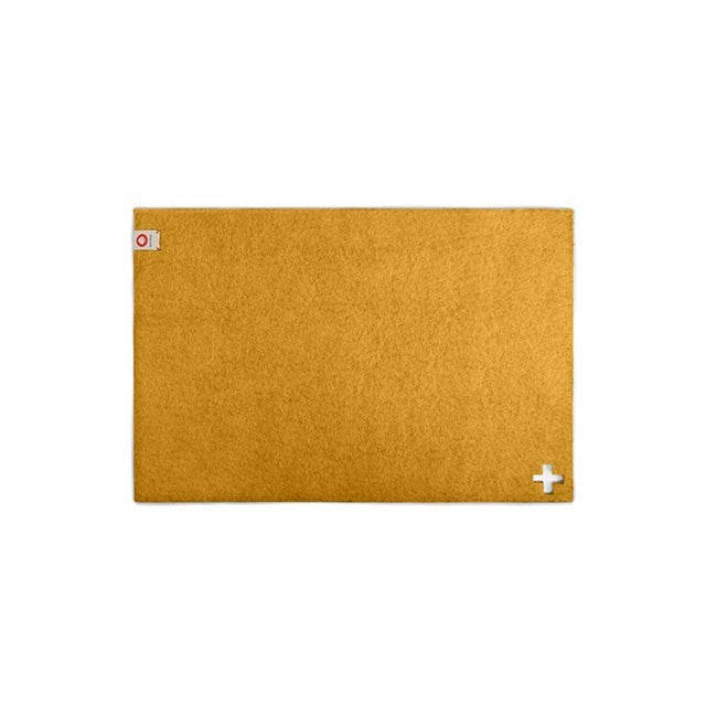 Baabuk honey yellow rectangular felted wool table mat with a small Swiss cross detail.