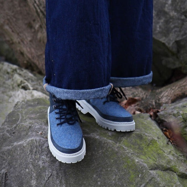 Baabuk Ice Wooler Blue Raisa boots featuring blue wool upper, nubuck trim, and white lug sole worn with denim jeans.