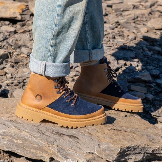 Baabuk Ice Wooler boots in navy wool and brown nubuck leather with a rugged rubber sole worn on rocky terrain.