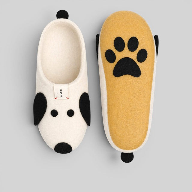 Baabuk Kanga Woof slippers in off-white wool with black dog ear details and a paw print on the natural latex sole.