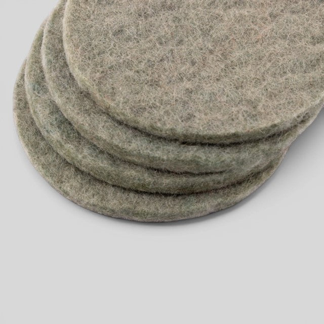 Baabuk set of four round khaki felted wool coasters for furniture protection