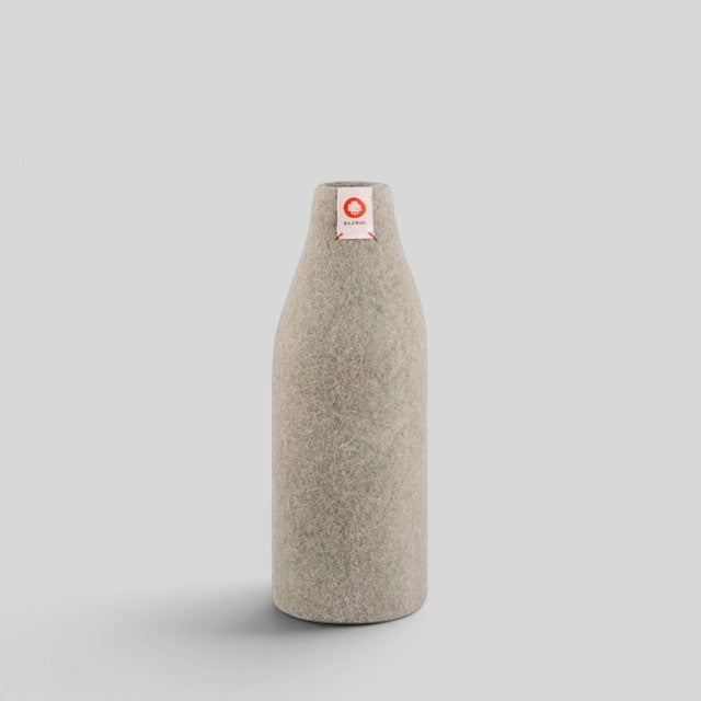 Baabuk khaki wool bottle cover with natural insulation and a small red branded tag on a neutral background.