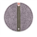 Baabuk round khaki felted wool potholder with a leather hanging strap and branded fabric tag