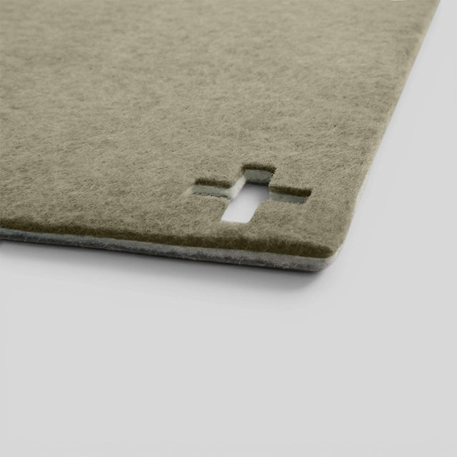 Baabuk khaki felted wool table mat with a Swiss cross cutout detail, handmade from natural New Zealand wool.