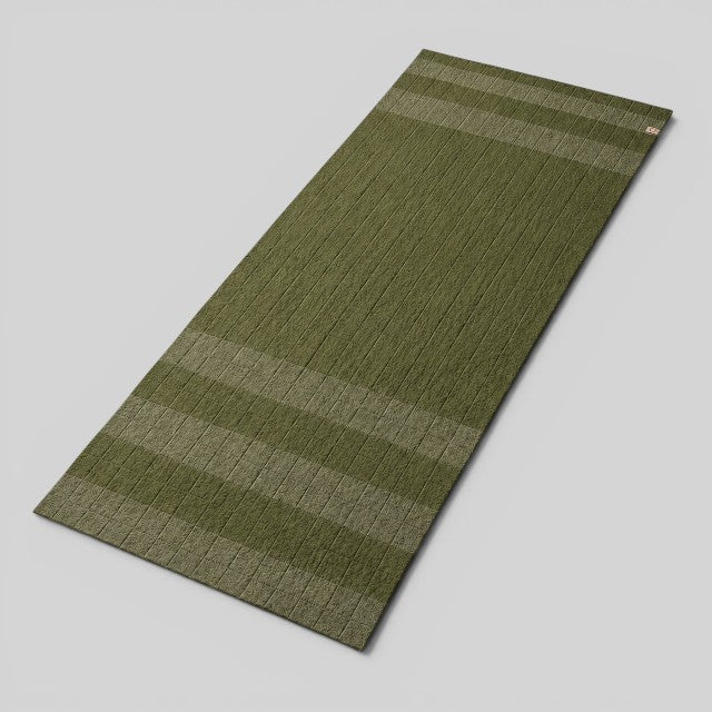 Baabuk khaki felted wool yoga mat with striped design and cotton stitching for a soft, natural practice surface.