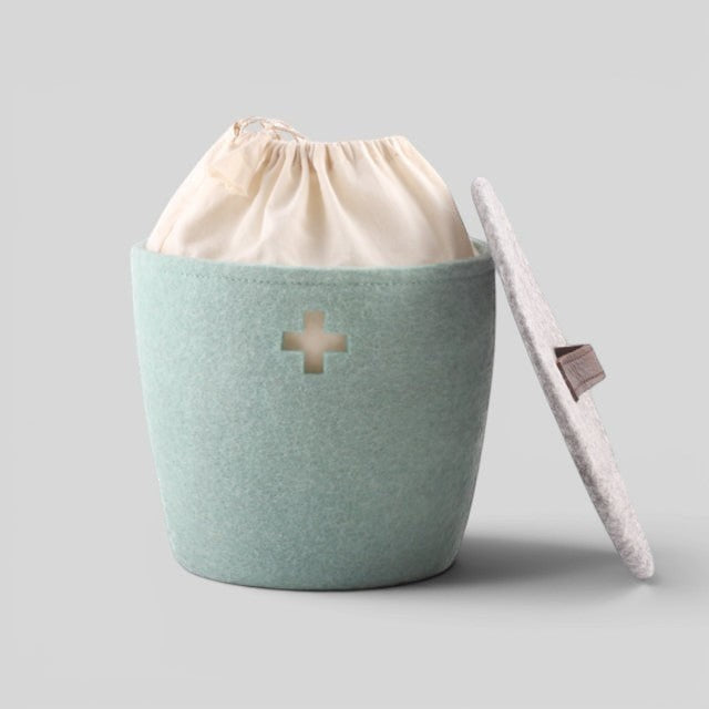 Baabuk small light blue felted wool basket with a Swiss cross cutout, fabric liner, and a grey lid with leather tab.
