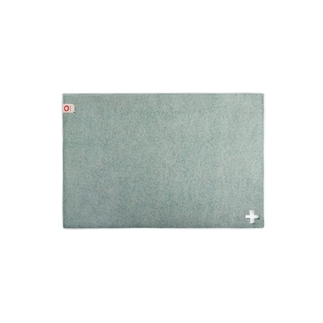 Baabuk light blue felted wool table mat with Swiss cross detail, handmade from New Zealand wool.