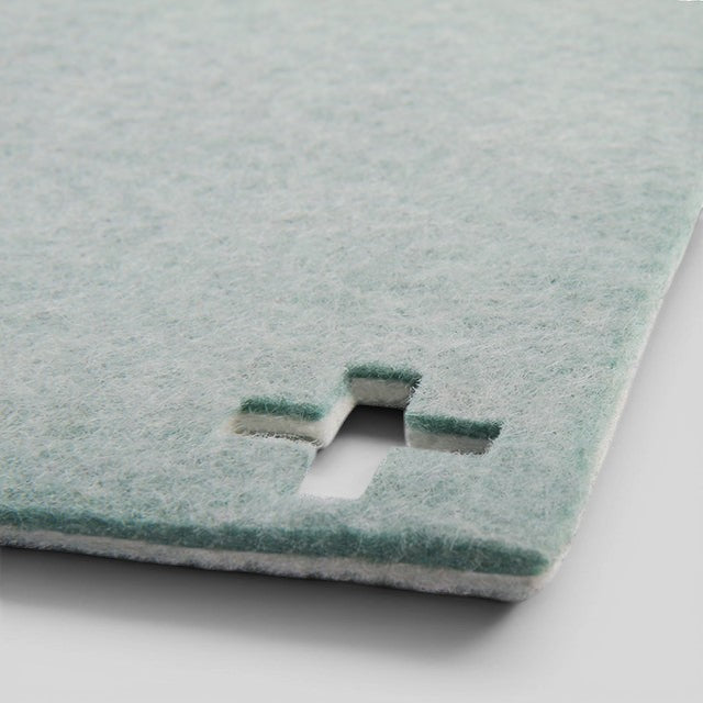 Baabuk light blue felted wool table mat with a Swiss cross cutout detail, handmade from natural New Zealand wool.