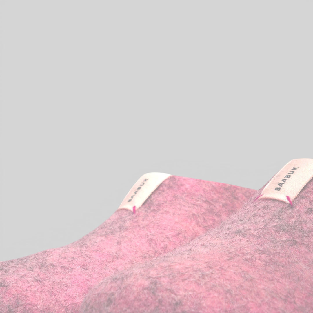 Baabuk Mel pink wool slippers with branded fabric tabs, handmade from natural New Zealand wool.