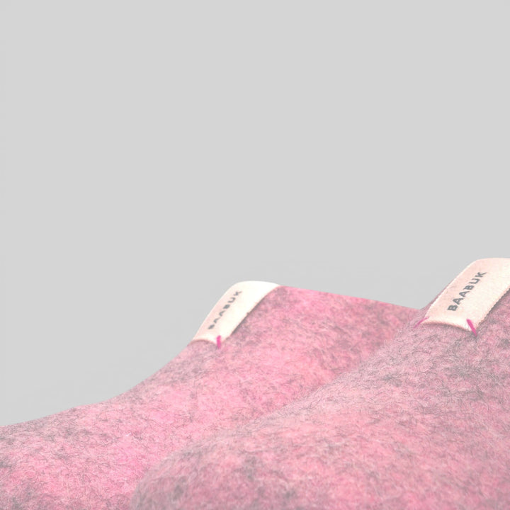 Baabuk Mel pink wool slippers with branded fabric tabs, handmade from natural New Zealand wool.