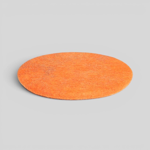Baabuk round orange sitting mat handmade from natural New Zealand wool with upcycled wool stuffing