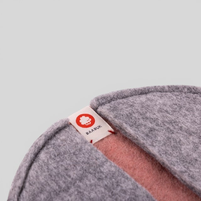 Baabuk pink and grey felted wool potholder with a branded fabric tag, handmade from natural New Zealand wool.
