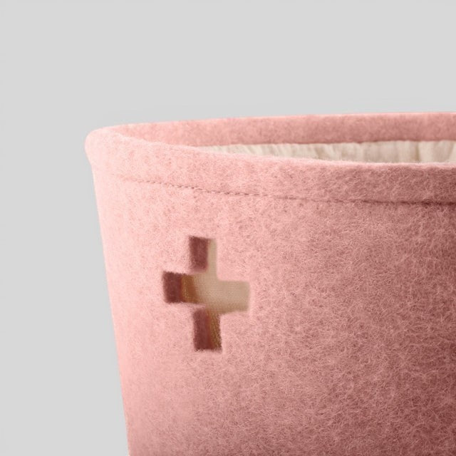Baabuk small pink felted wool basket with a Swiss cross cutout design, handmade from natural New Zealand wool.