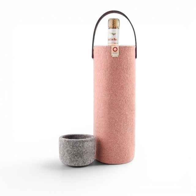Baabuk pink wool wine cooler with a leather strap and a matching grey wool base, holding a wine bottle.
