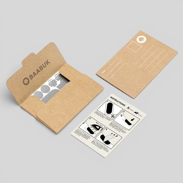 Baabuk repair kit featuring iron-on patches, instruction card, and branded kraft paper envelope.