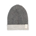 Baabuk reversible dark grey and light grey baby alpaca wool beanie with a small branded tag on the folded cuff.