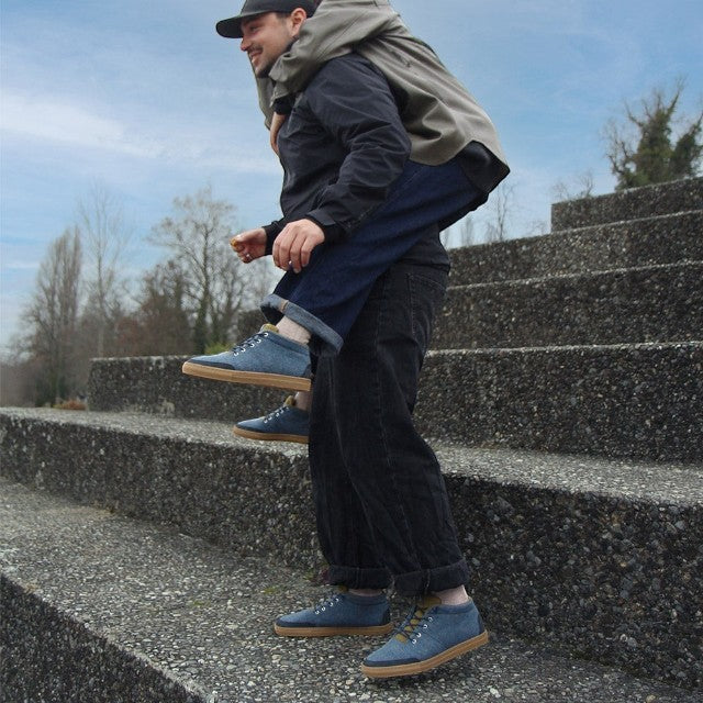 Baabuk Sky Wooler Blue Raisa sneakers with wool upper and rubber sole worn by a man giving a piggyback ride