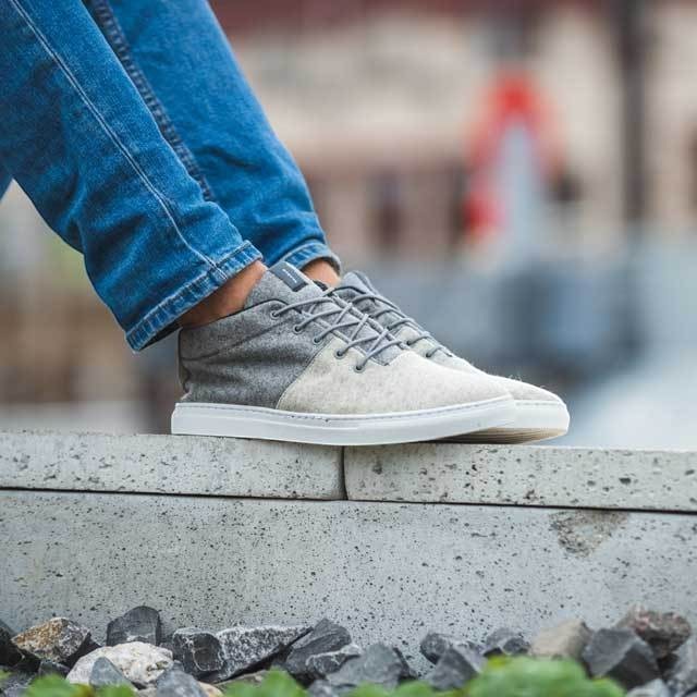 Baabuk Sky Wooler sneakers in middle grey wool with elastic laces and a white rubber sole worn with blue jeans.