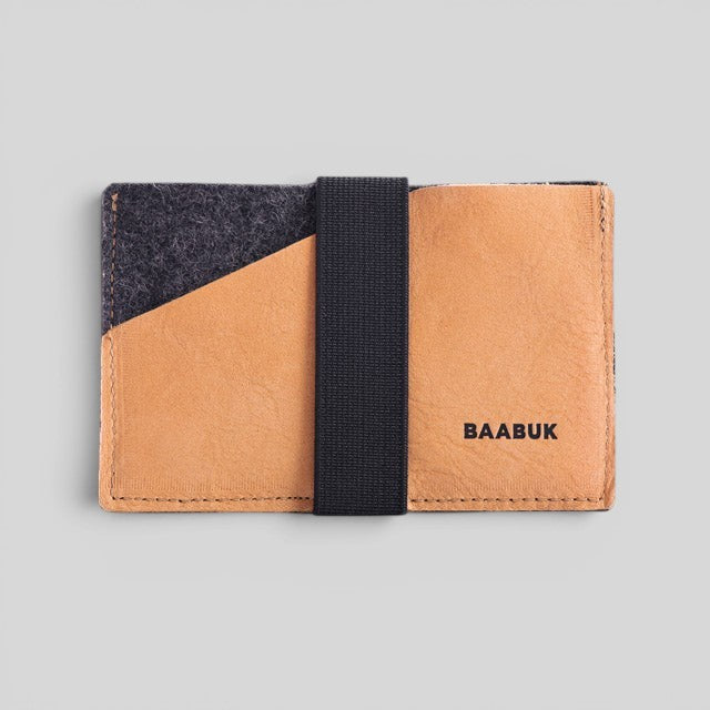 Baabuk slim wallet in grey wool and tan leather with a secure black elastic strap for cards and cash.