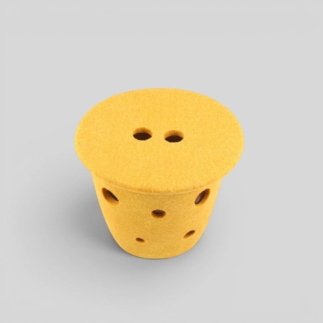 Baabuk small yellow felted wool basket with Swiss cheese-inspired holes and a leather strap, handmade in Nepal.