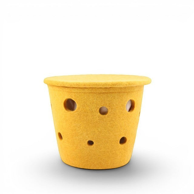 Baabuk small yellow felted wool basket with Swiss cheese-inspired hole design for kitchen or home storage.