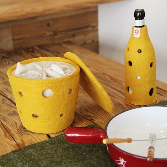 Baabuk small yellow felted wool basket with Swiss cheese hole design, perfect for kitchen storage or fondue tables.