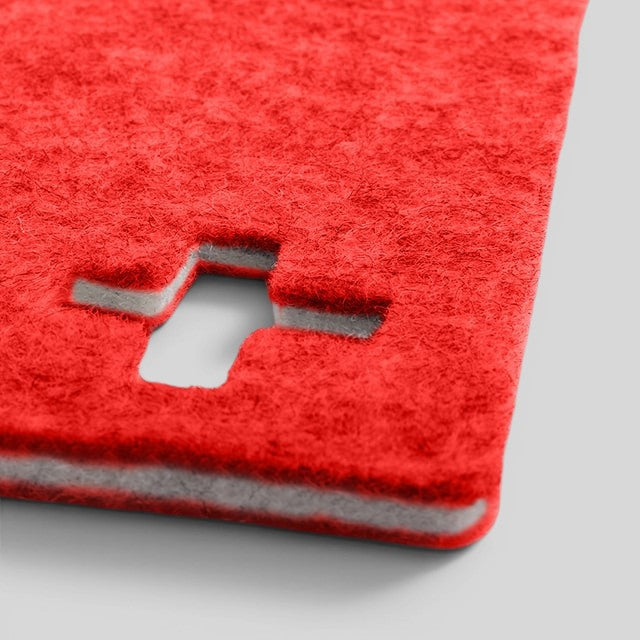 Baabuk Swiss Red felted wool table mat with a die-cut Swiss cross design, handmade from natural New Zealand wool.