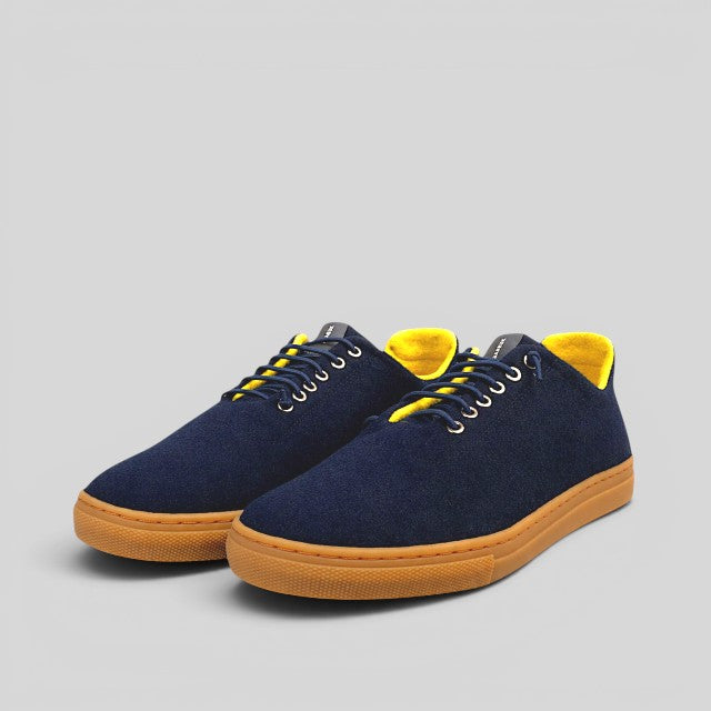 Baabuk Urban Wooler sneakers in navy blue wool with a bright yellow interior lining and gum rubber sole.