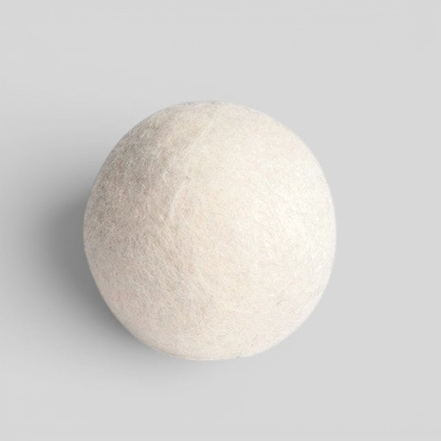 Baabuk handcrafted white wool dryer ball for sustainable, chemical-free laundry softening and faster drying.