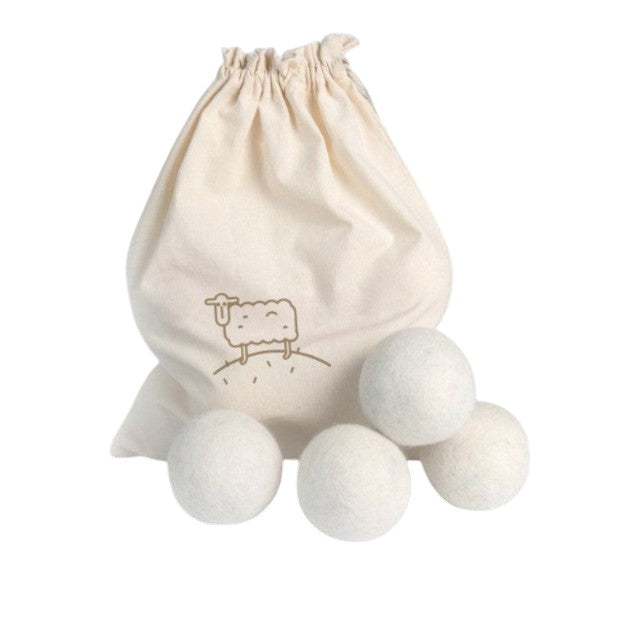 Set of 4 white Baabuk wool dryer balls with a branded cotton drawstring carry bag for sustainable laundry care.