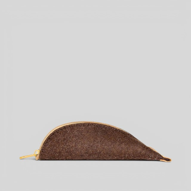 Baabuk brown wool pencil case with leather accents and a zipper closure. Sized for pencils, glasses, and accessories.
