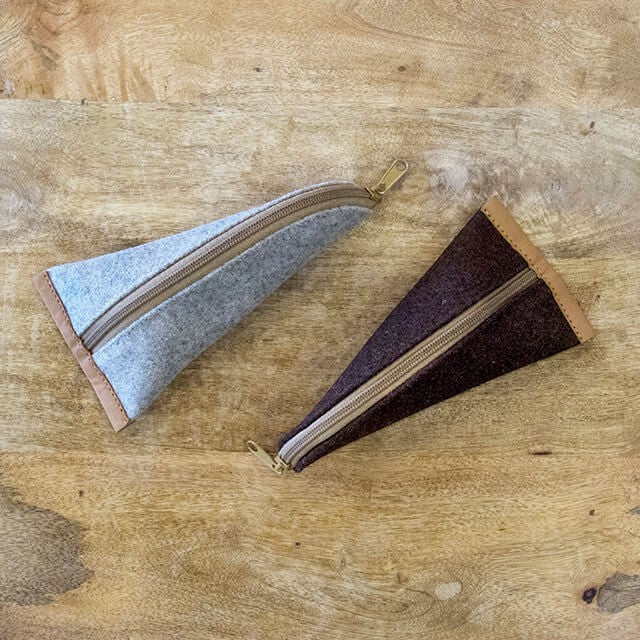 Baabuk grey and brown wool pencil cases with leather accents and zippers, 20cm x 10cm.