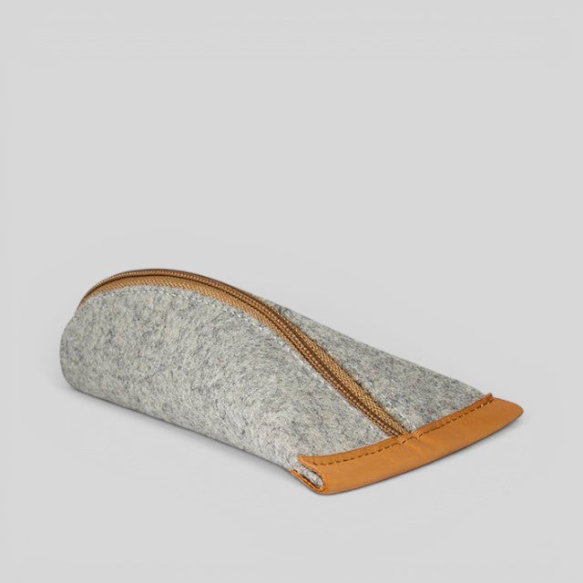 Baabuk grey wool pencil case with leather accents and a gold zipper closure. Sized for pencils, glasses, or headphones.